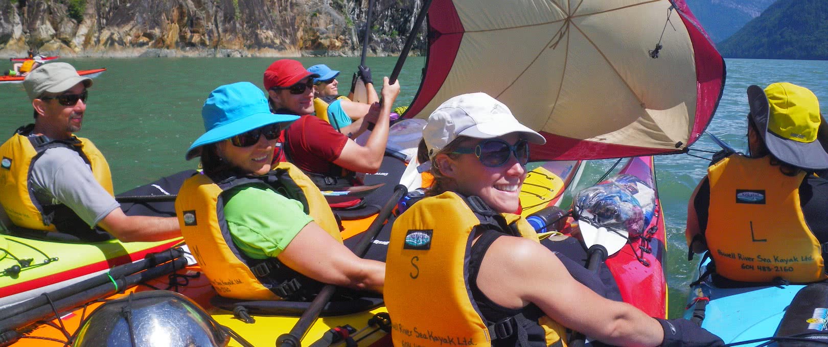 Kayakers catching some wind with a sail